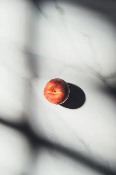 Top view of fresh peach on light marble tabletop — Stock Photo