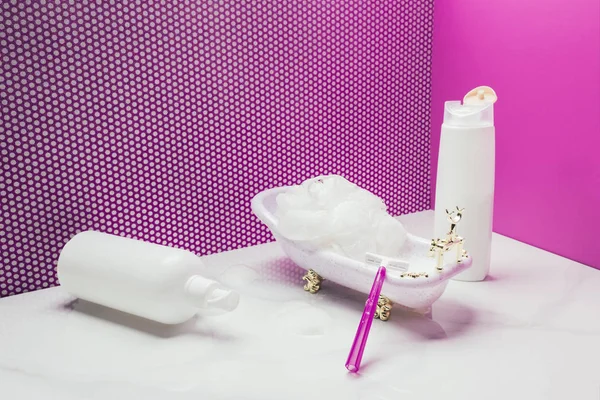 Bath with real size hygiene supplies in miniature bathroom — Stock Photo