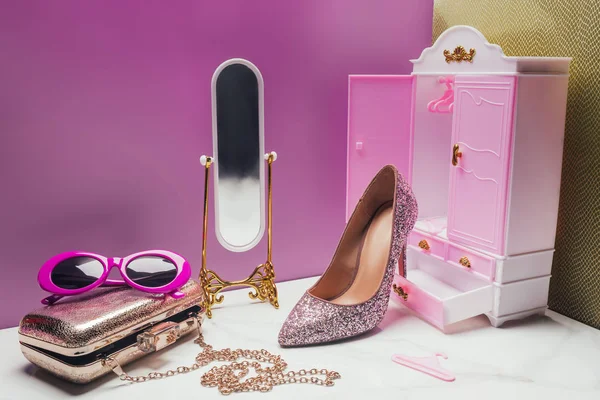 Toy wardrobe and mirror with real size various female accessories in miniature pink room — Stock Photo