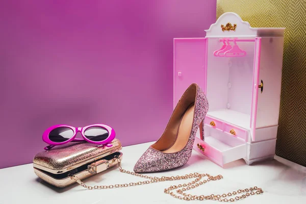 Toy wardrobe with real size stylish female accessories in miniature pink room — Stock Photo