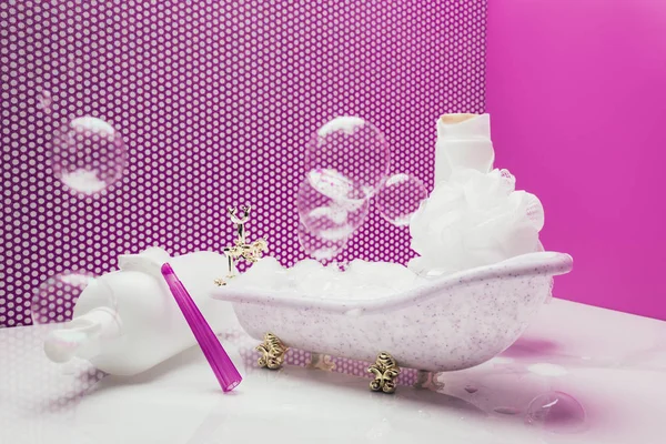 Banho de brinquedo com suprimentos de higiene pessoal de tamanho real e bolhas de sabão na sala em miniatura — Fotografia de Stock