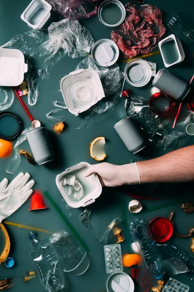 Partial view of man in latex glove cleaning water from trash, ecology protection concept — Stock Photo