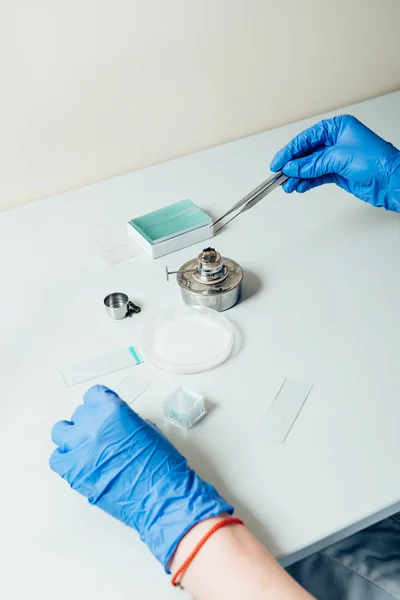 Imagen recortada de biólogo trabajando con pinzas en laboratorio moderno - foto de stock