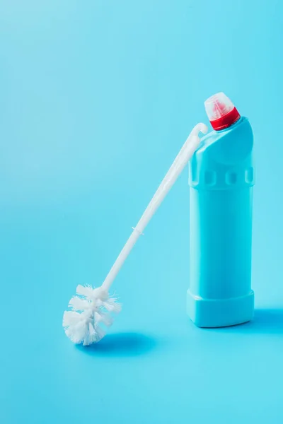 Vue rapprochée de la brosse de toilette et du liquide de nettoyage, fond bleu — Photo de stock