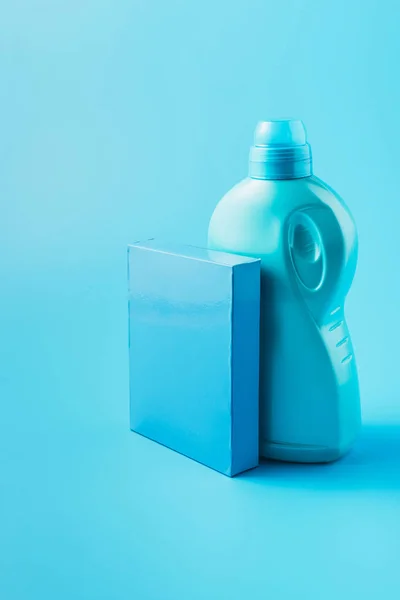Close up view of washing powder and laundry liquid, blue background — Stock Photo