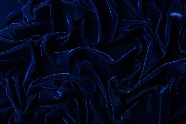 Вид зверху на темно-синій оксамитовий текстиль як фон — стокове фото