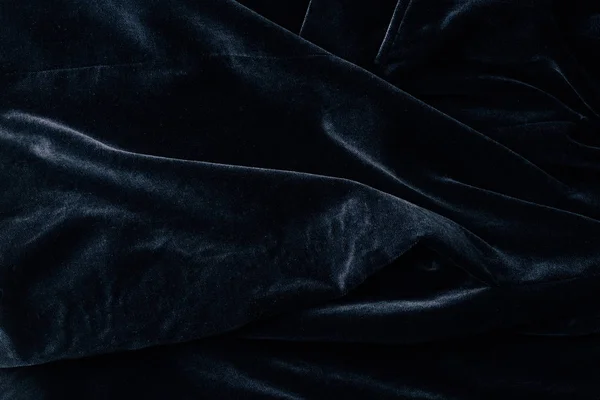 Верхний вид черного бархатного текстиля в качестве фона — стоковое фото