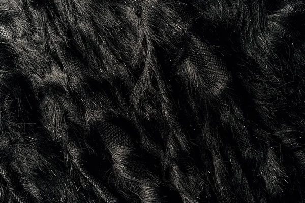 Vista elevada do têxtil preto peludo como fundo — Fotografia de Stock