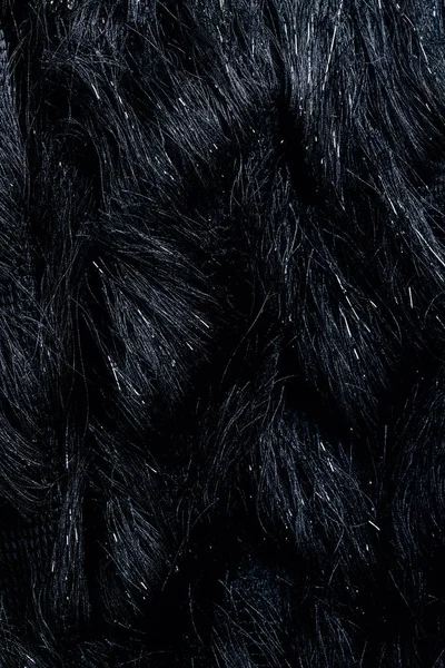 Vue du dessus du textile noir fourrure comme arrière-plan — Photo de stock