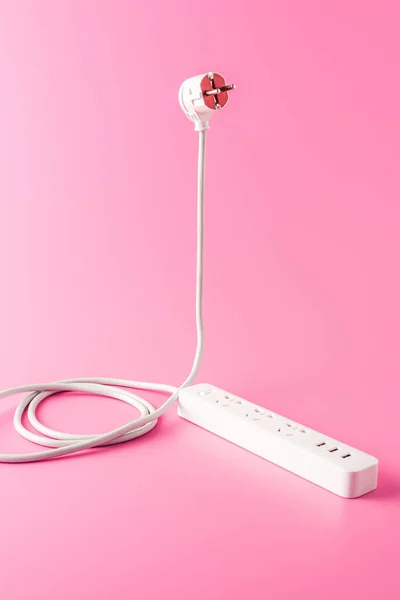 Close-up view of white socket outlet and plug isolated on pink — Stock Photo