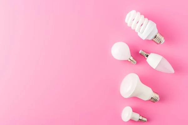 Top view of various types of lamps on pink background — Stock Photo