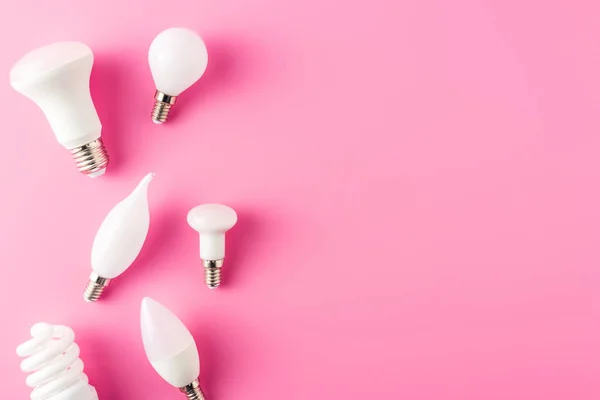 Top view of various types of light bulbs on pink background — Stock Photo