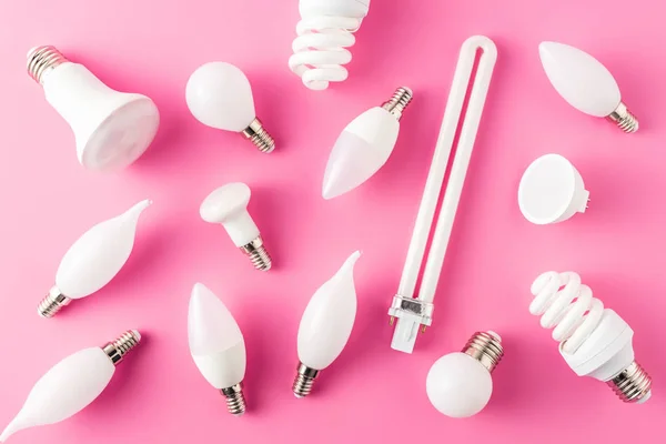 Top view of various types of light bulbs on pink — Stock Photo