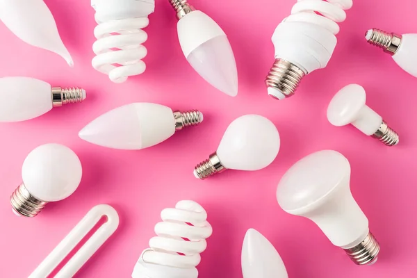 Top view of various light bulbs on pink background — Stock Photo