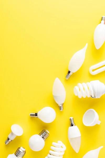 Top view of various types of light bulbs on yellow background — Stock Photo