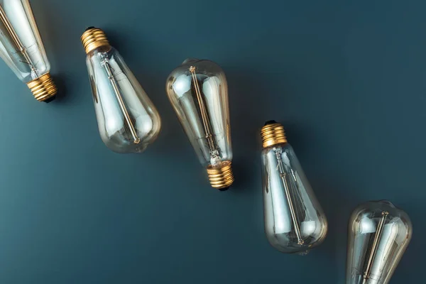 Close-up view of light bulbs on grey background, energy concept — Stock Photo