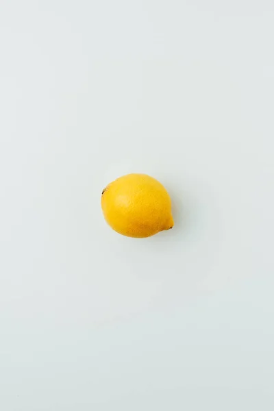 Top view of one yellow lemon, on grey — Stock Photo