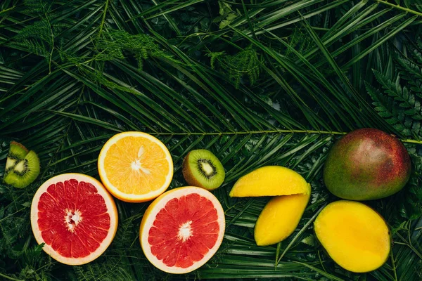 Vista superior de frutas tropicais orgânicas em folhas de palmeira com espaço de cópia — Fotografia de Stock