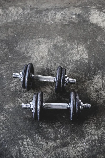 High angle view of adjustable dumbbells on concrete surface — Stock Photo