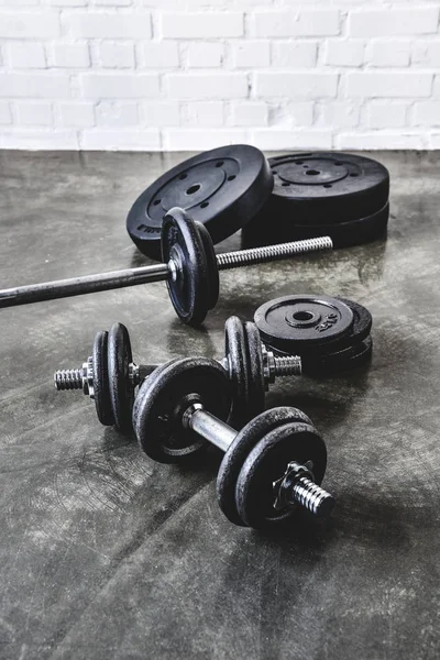 Various gym equipment on concrete surface — Stock Photo