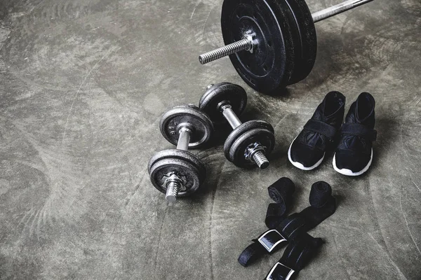 Various workout equipment on concrete surface — Stock Photo