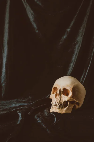 Scary skull on black cloth with spider web for halloween — Stock Photo