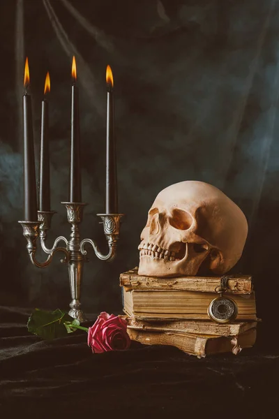 Halloween decorations and skull on black cloth with smoke — Stock Photo