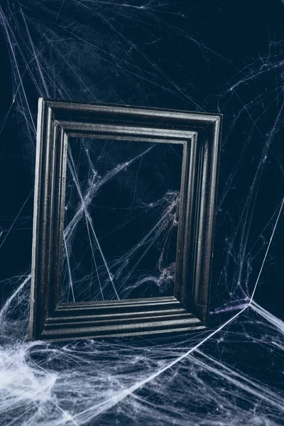 Black frame in spider web, creepy halloween decor — Stock Photo