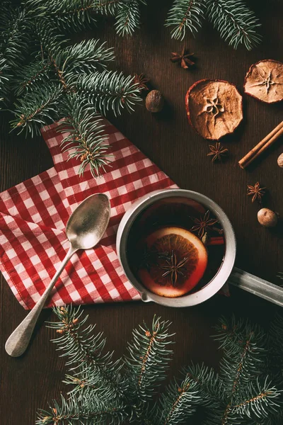 Top view of homemade traditional mulled wine with spices on wooden background — Stock Photo