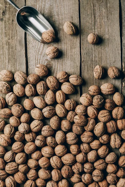 Top view of ripe tasty walnuts on wooden table — Stock Photo