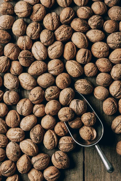 Top view of raw ripe organic walnuts on wooden table — Stock Photo