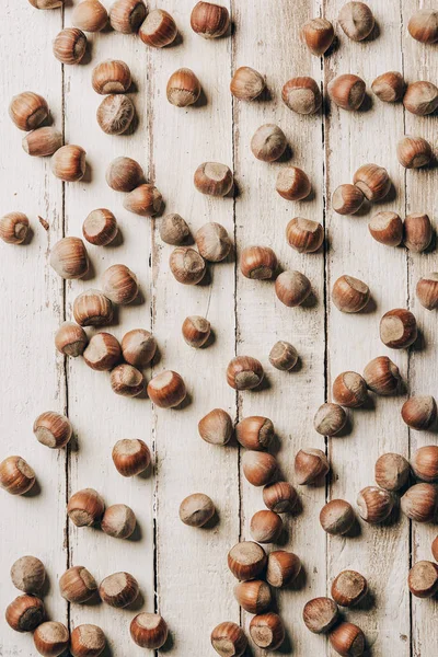 Top view of raw ripe healthy hazelnuts on wooden table — Stock Photo