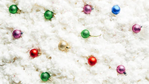 Top view of colorful christmas toys on white cotton wool background — Stock Photo