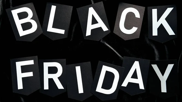 Top view of black friday lettering on black background — Stock Photo