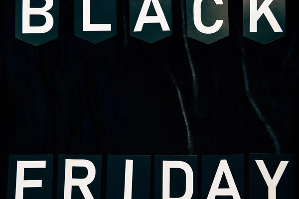 Top view of black friday lettering on black background — Stock Photo