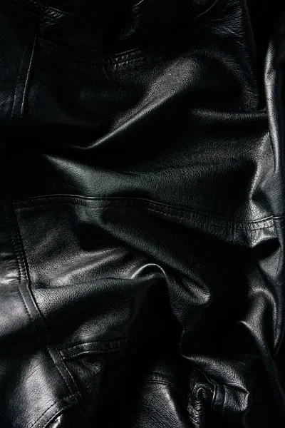 Full frame of black leather jacket as background — Stock Photo