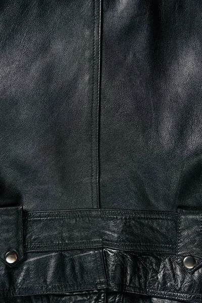 Full frame of black leather jacket as background — Stock Photo