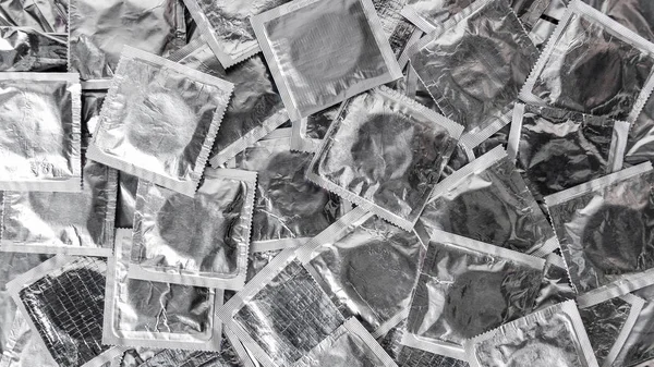 Top view of pile of silver condoms — Stock Photo