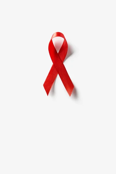 Top view of aids awareness red ribbon on white background — Stock Photo