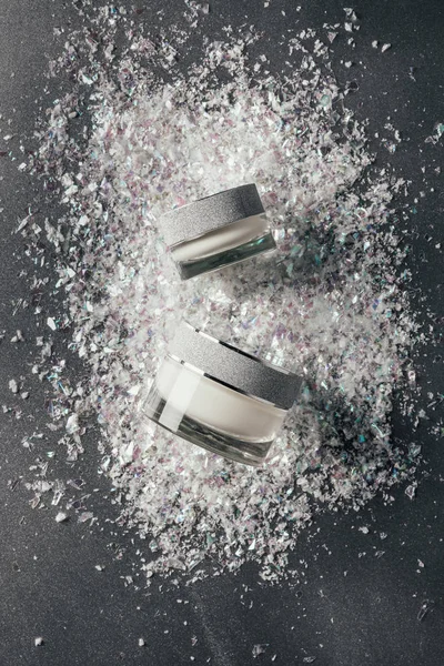 Elevated view of beauty cream with decoration shavings on silver — Stock Photo