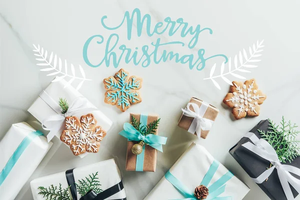 Flat lay with christmas gift boxes and snowflake cookies on marble background with 