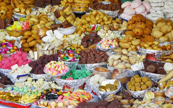 Traditional sweets: cookies, jelly, candy, chocolate, marshmallow, candied fruits, nuts and more at open market during catholic Corpus Christi celebration in Ecuador in Cuenca