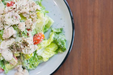 Sezar salatası kopya alanı ile bir tabak içinde restoranda menüsüdür.