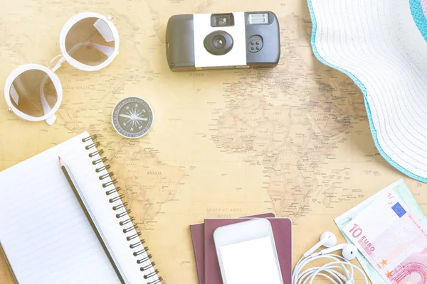 Travel concept.  Flat lay travel accessories about camera, hat and smartphone.