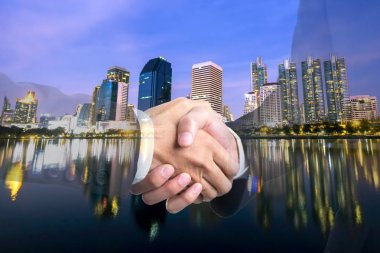 El iş adamları başarı anlaşma için modern şehir geceleri sallayarak çift pozlama