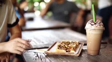 Buzlu kahve ile tost ekmek yiyen kadınlar