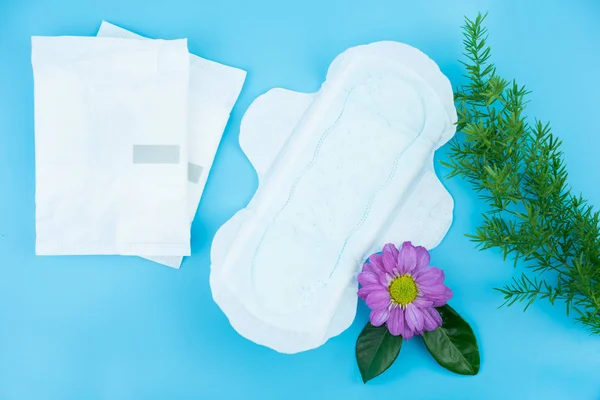 Sanitary napkin with flowers on blue background