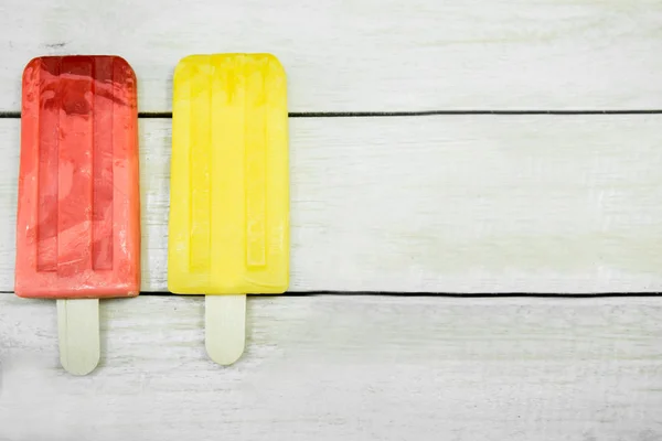 Ice cream stick on a wooden background.  Summer food concept.