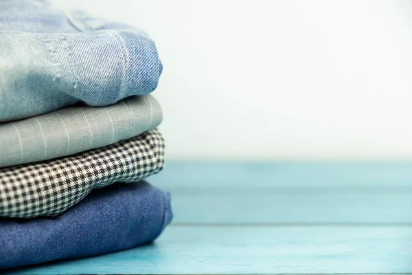 Stacked clothes and pants on isolated white — Stock Photo, Image