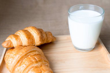 Kruvasan ve süt masada.